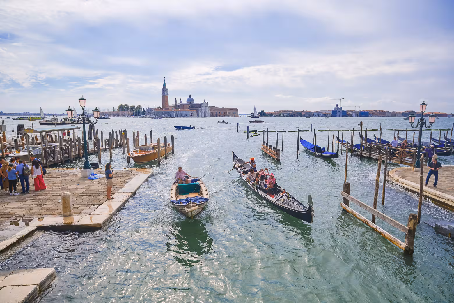 Gondolas and boats navigate Venice's bustling waterways, offering picturesque views of the city's landmarks.