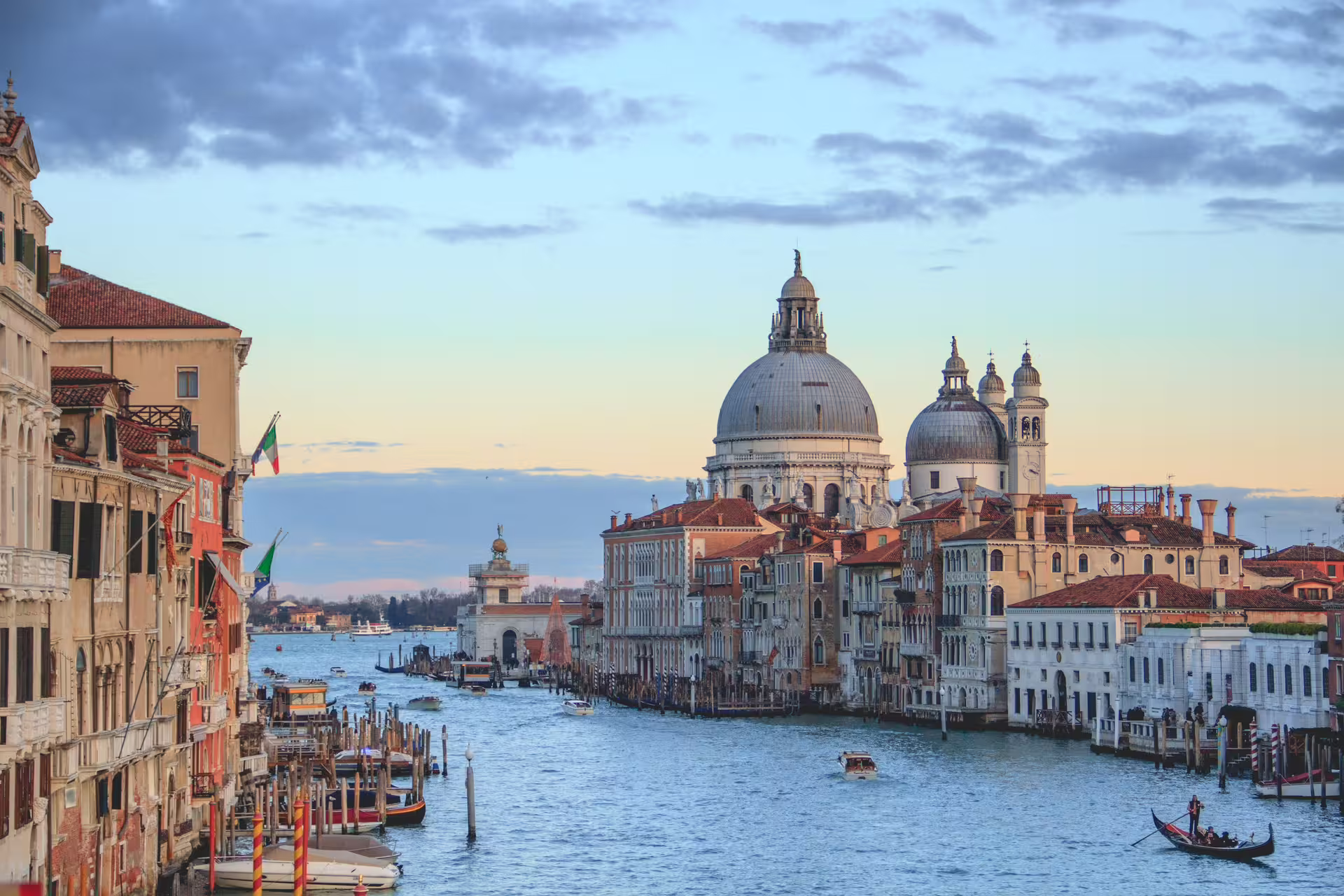 Sunset cruise on the Grand Canal toward Santa Maria della Salute, a highlight of a private 2-day Venice tour from Rome