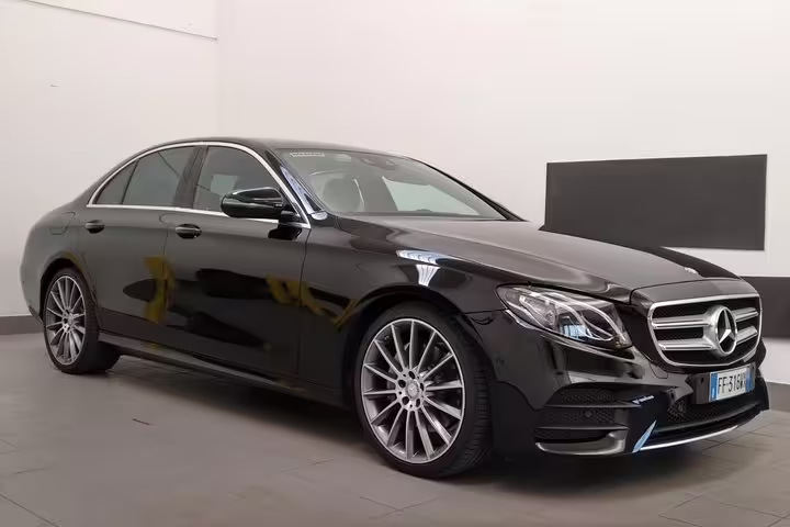 Elegant black Mercedes sedan offering premium private transfer service from Venice Marco Polo airport to Piazzale Roma.