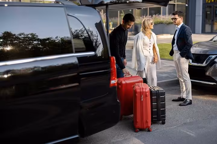 Travelers with luggage beside a luxury van, preparing for a Venice private transfer to Ravenna Porto Corsini Cruise Terminal.