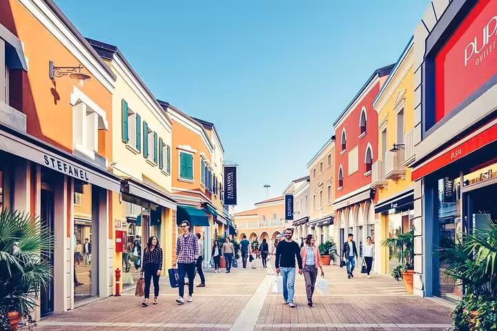 Vibrant shoppers stroll through a colorful Venetian shopping street, ideal for exploring before a cruise from Trieste.