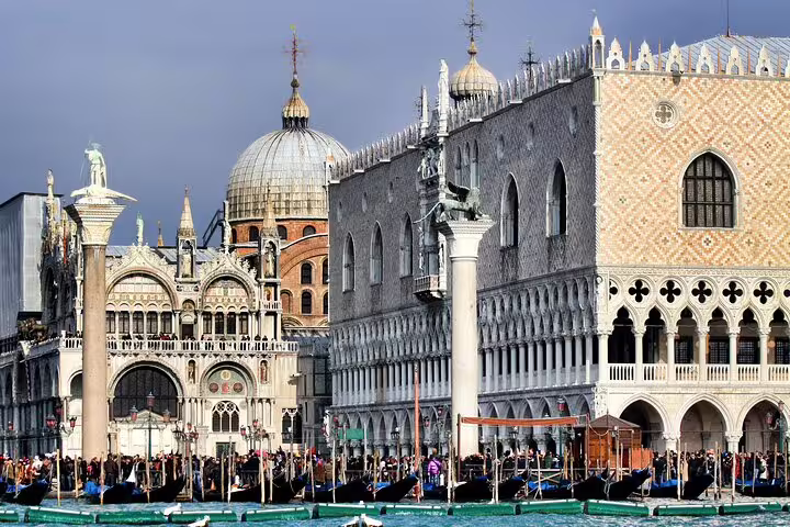 View of St Mark's Basilica and Doge's Palace from the Grand Canal with gondolas on a Venice skip-the-line guided tour