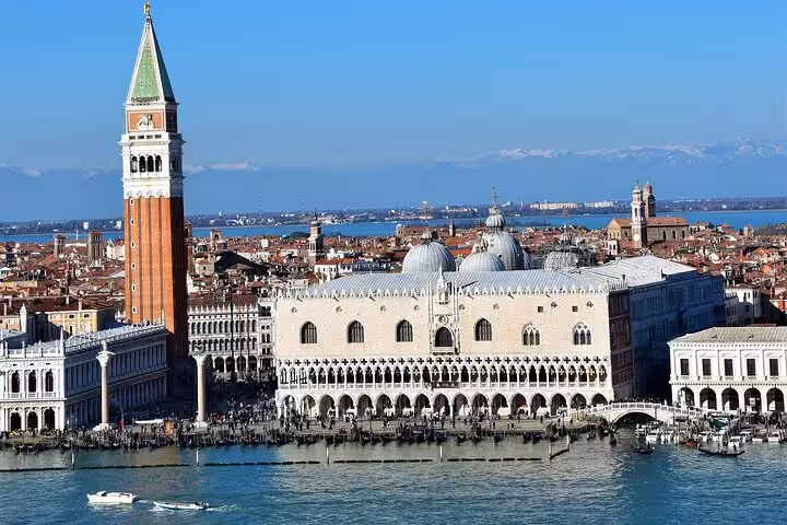 Visit Venice's majestic St. Mark's Bell Tower and Doge's Palace, offering panoramic views on a day trip from Florence.