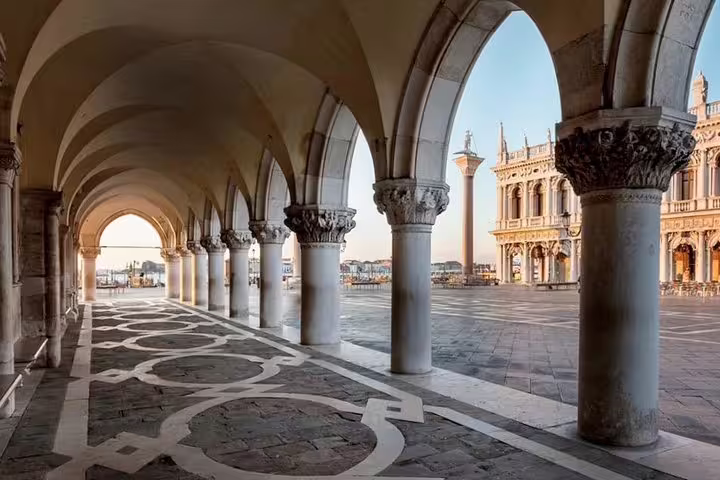 Sunrise view of ornate arches and columns in Venice, capturing the historic beauty on an early morning photo tour.