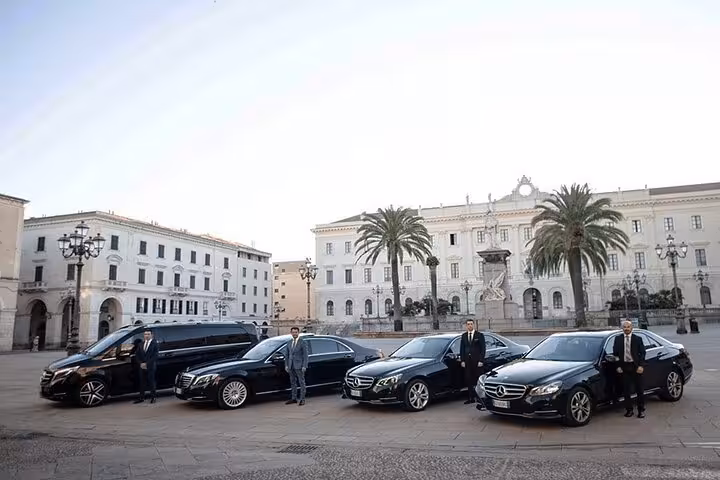 Luxurious private transfer vehicles with drivers ready for Venice to Trieste cruise port service in an elegant plaza.