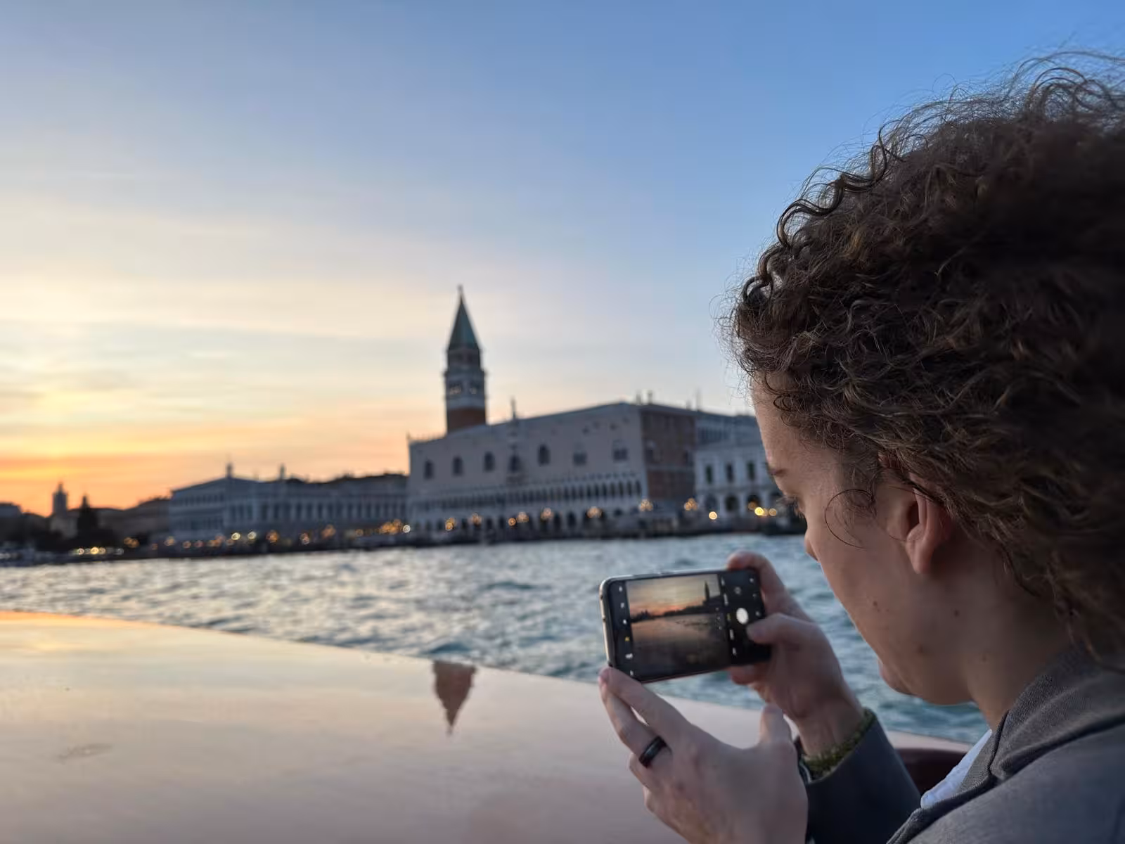 Traveler captures Venice skyline from water taxi near St Mark's Square during Marco Polo Airport transfer.