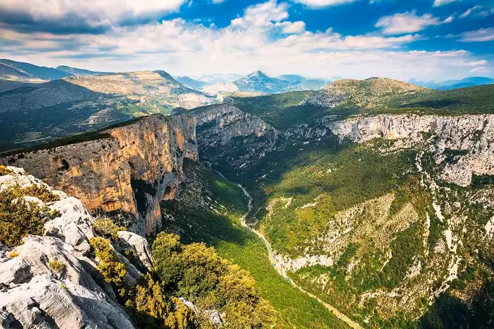 Stunning view of the Verdon Gorge, known as the Grand Canyon of Europe, with lush greenery and dramatic cliffs.