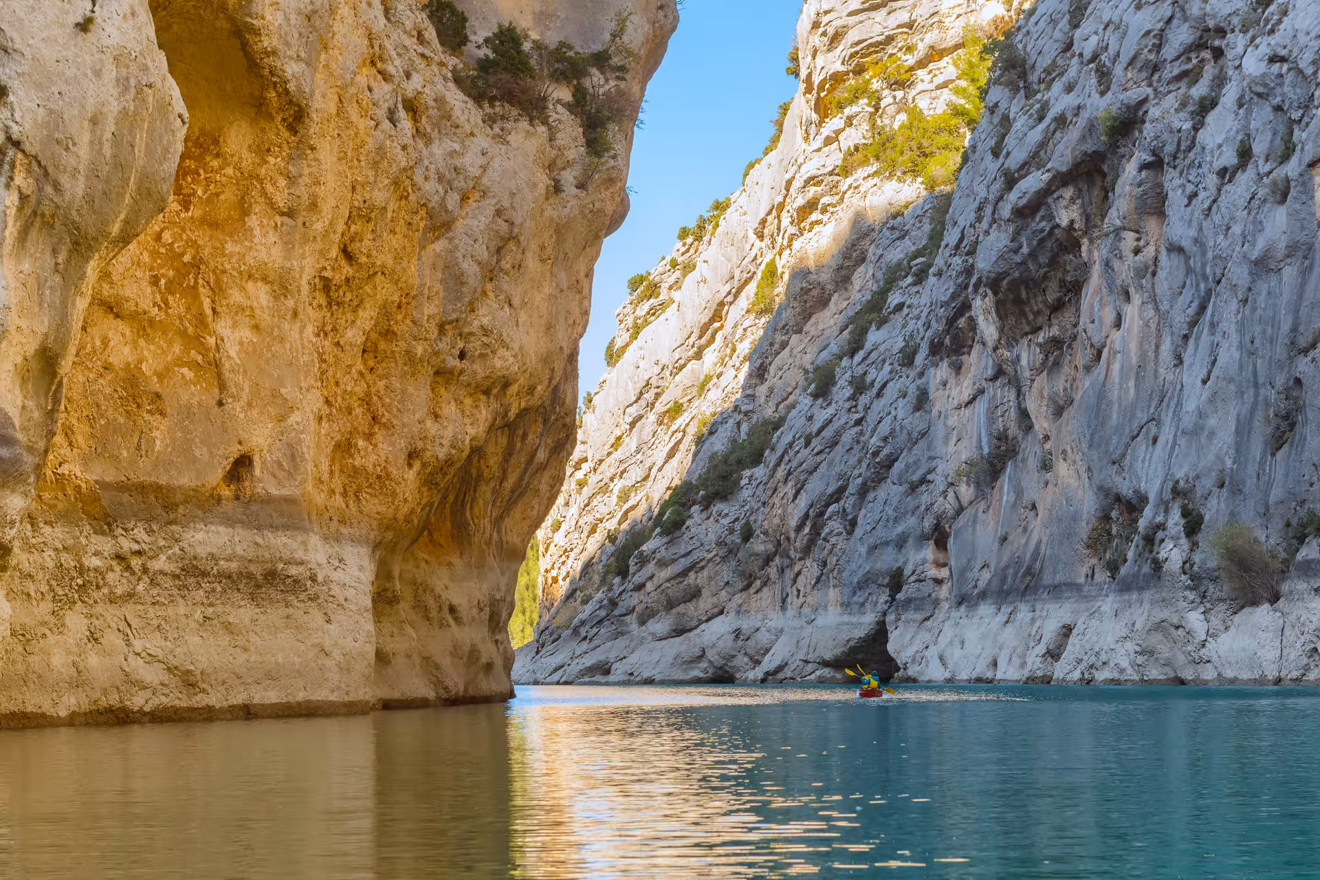 Kayaker paddling through towering limestone walls in Gorges du Verdon on a Verdon River 6D/5N hotel trip