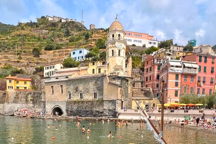 Vernazza beach with colorful buildings and church, a highlight on the From Florence 2-Day Combo Tour.
