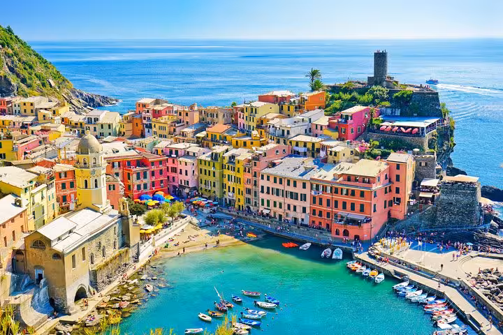 Vibrant Vernazza village with colorful buildings along the coast in Cinque Terre, ideal for hiking tours from La Spezia.