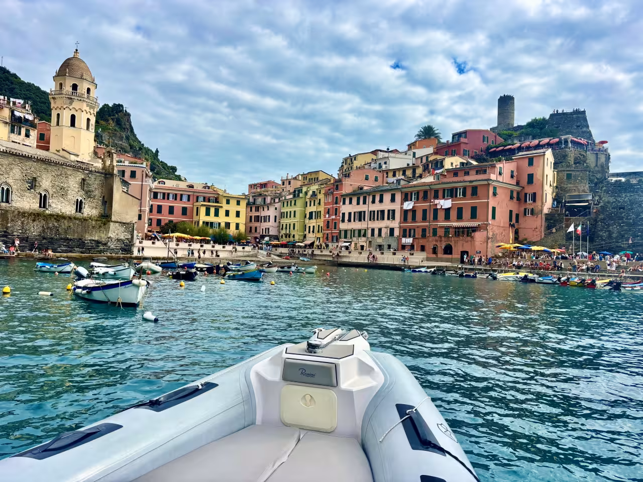 Boat view of Vernazza harbor on a Cinque Terre full-day boat tour from La Spezia, Italy coastline