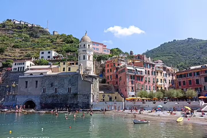 Colorful Vernazza village and church seen from the sea on a shore excursion transfer from La Spezia to Cinque Terre