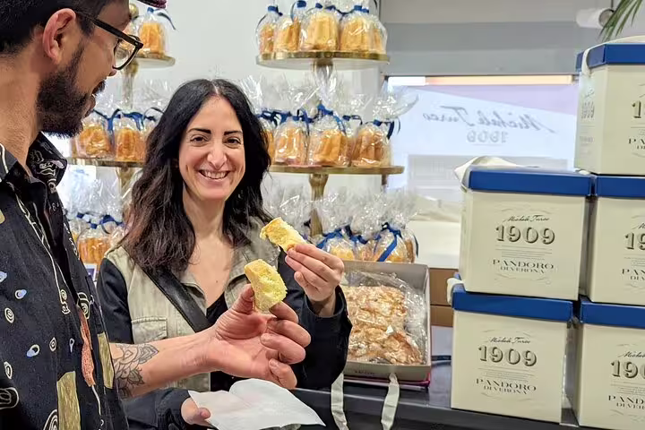 Guests tasting traditional pandoro cake in a Verona bakery stop on guided food tour with wine tasting