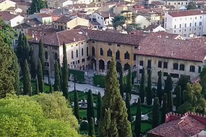 Panoramic Verona hillside view over cypress gardens and terracotta rooftops on guided walking tour