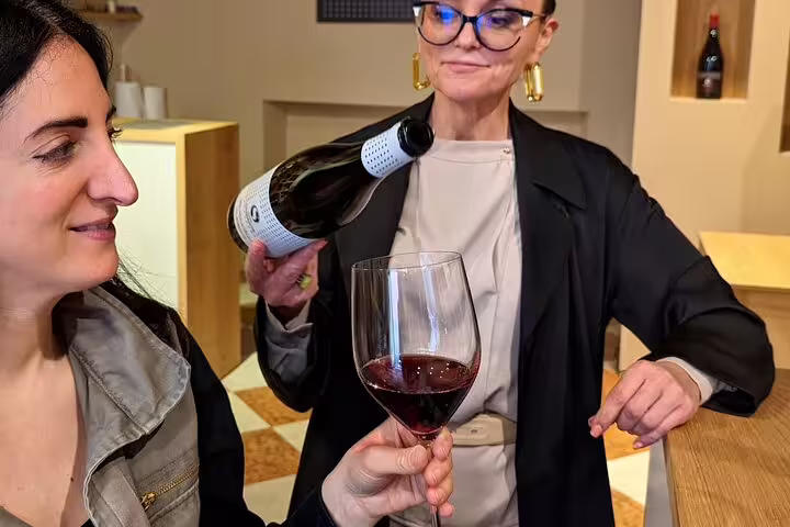 Red wine tasting in Verona as guide pours Valpolicella during guided food tour with local pairings