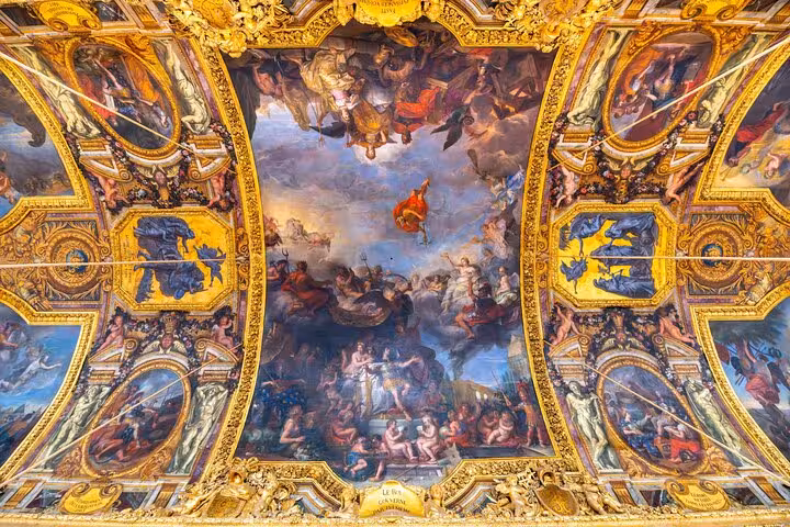 Versailles Palace guided tour highlights the gilded Baroque ceiling fresco inside the grand state rooms