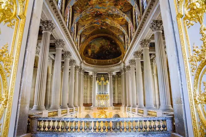 Guided Versailles Palace tour inside the Royal Chapel with gilded columns and painted vaulted ceiling