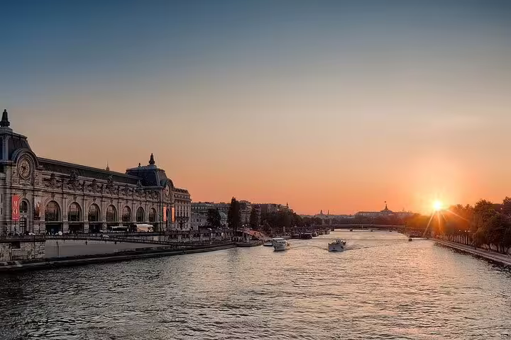Seine River sunset near Musée d’Orsay in Paris, view during Versailles private round-trip transfer by car