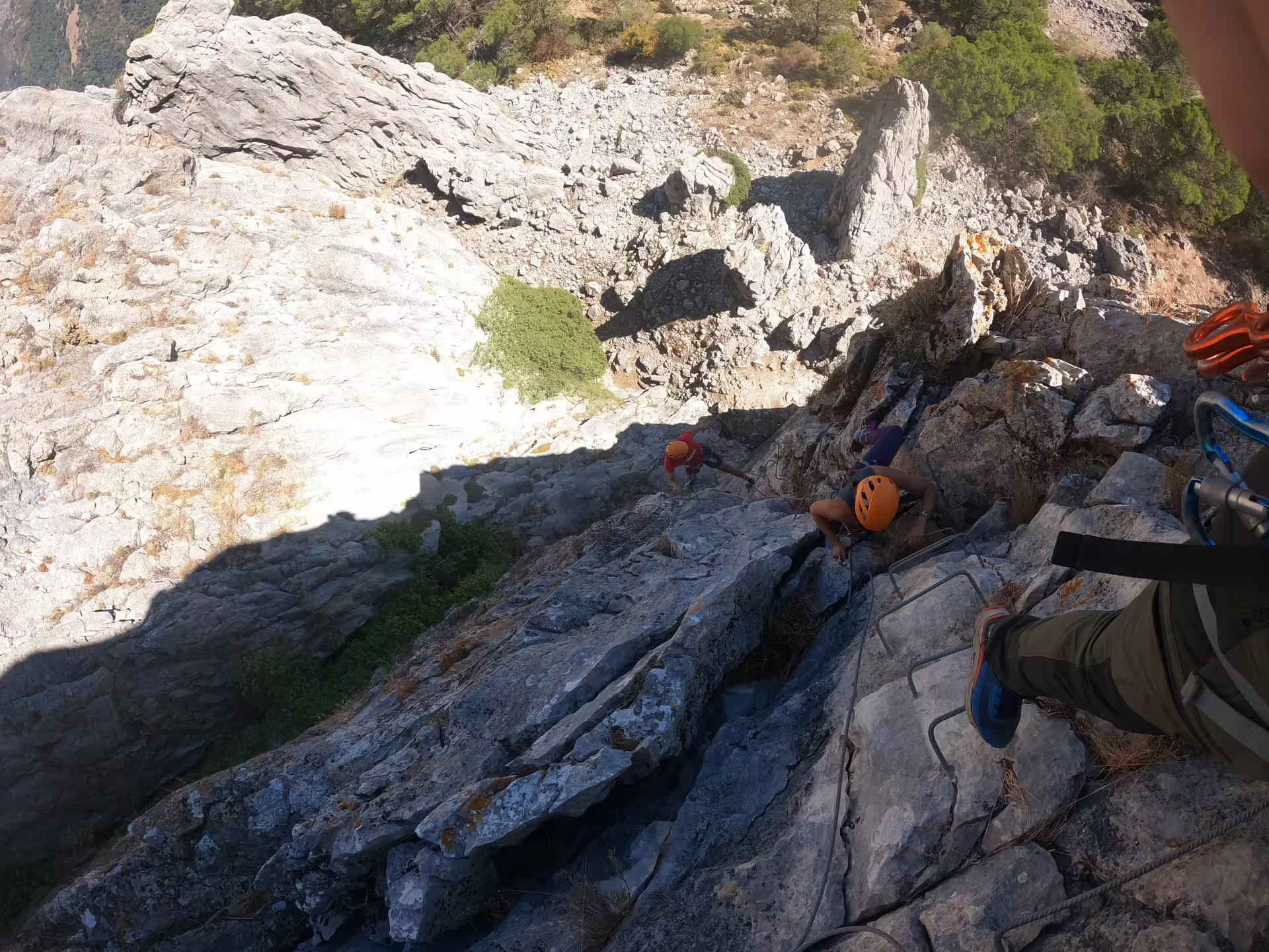 Climbers navigate the rugged Via Ferrata Benadalid with safety gear, offering stunning views of Costa del Sol's rocky landscape.