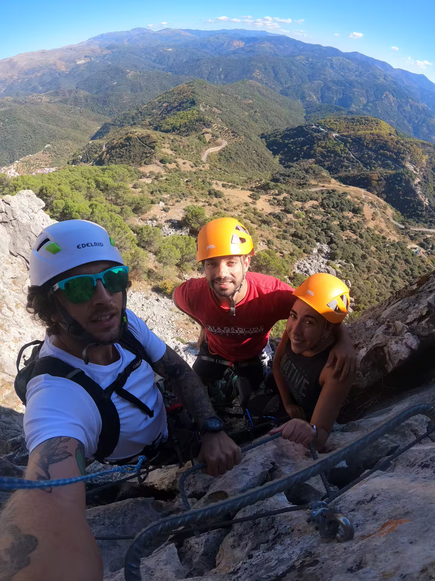 Adventurers climbing Via Ferrata Benadalid, enjoying challenging heights and stunning views of Costa del Sol landscape.