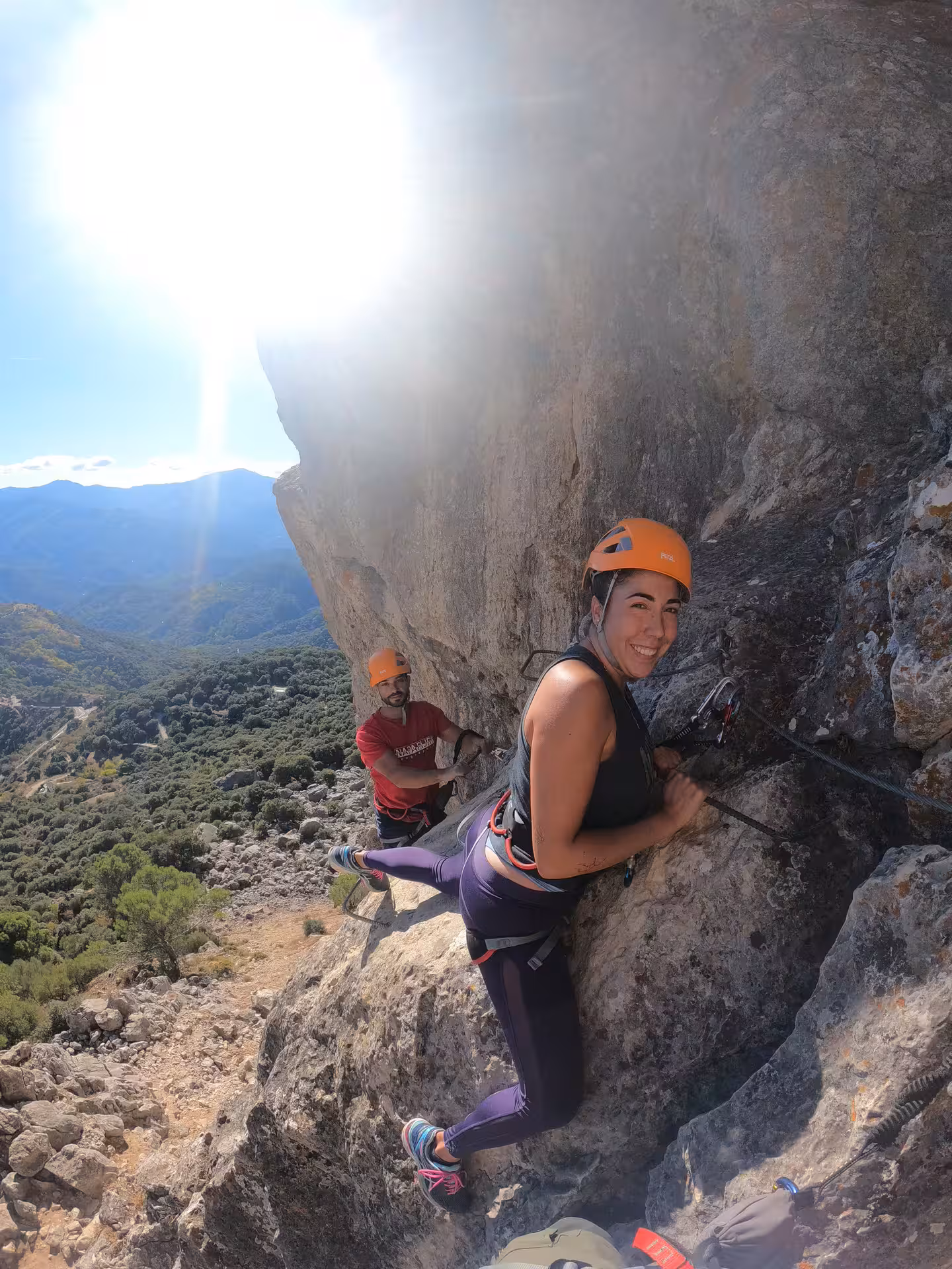 Participants enjoying a thrilling Via Ferrata climb in Benalauría, showcasing breathtaking vistas of Costa del Sol's natural beauty.