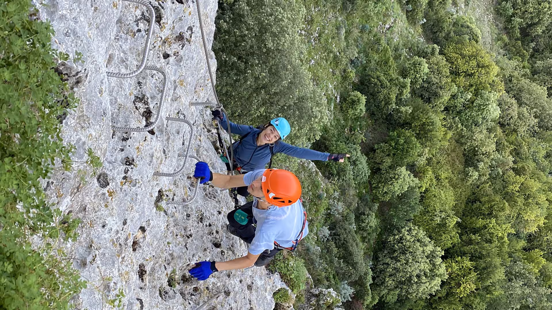 Adventure seekers climbing Via Ferrata di Giorré in Cargeghe, amidst stunning natural scenery and vertical challenges.