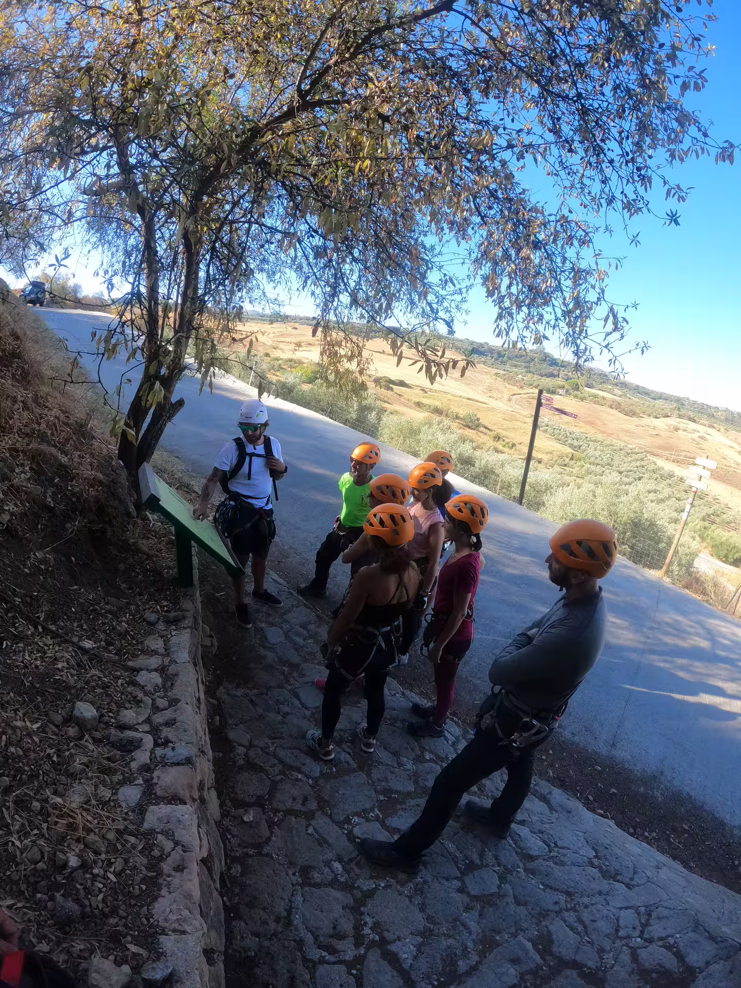 Group of climbers wearing helmets gather at the start of Via Ferrata Tajo de Ronda for an exhilarating adventure in Spain.