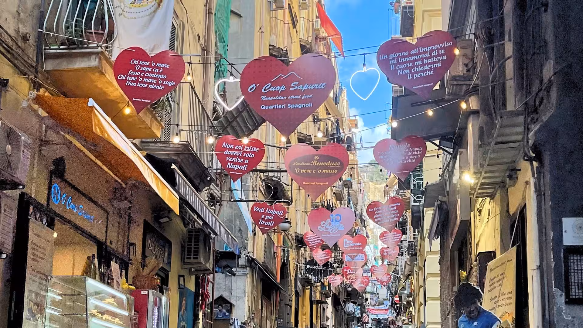 Charming Via Toledo street in Naples decorated with heart-shaped signs, capturing local culture and romantic ambiance.