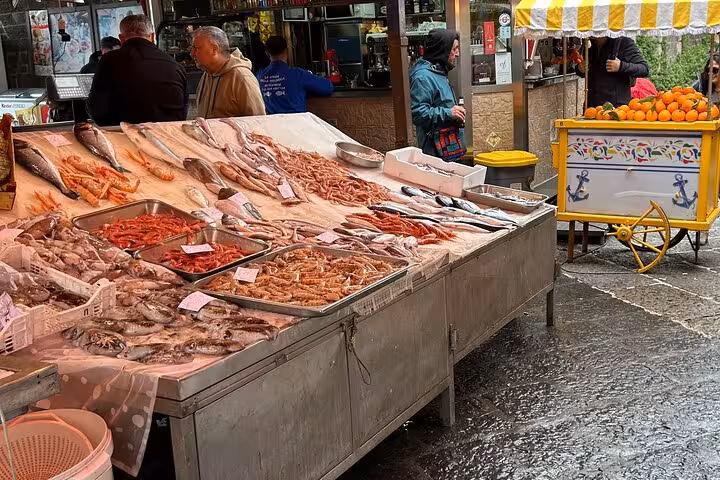 Vibrant fish market in Catania showcasing fresh seafood and local produce on bustling street corner.