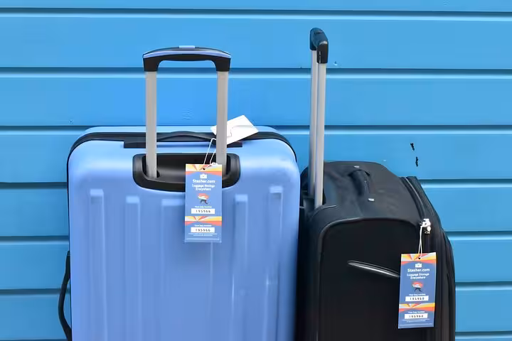 Two suitcases with Stasher tags ready for Vienna train station luggage storage, secure bag drop