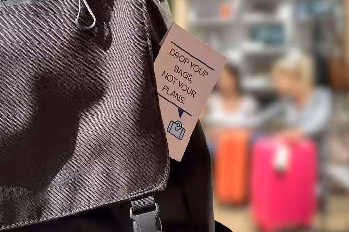 Backpack with tag promoting Vienna train station luggage storage for travelers needing secure bag drop-off