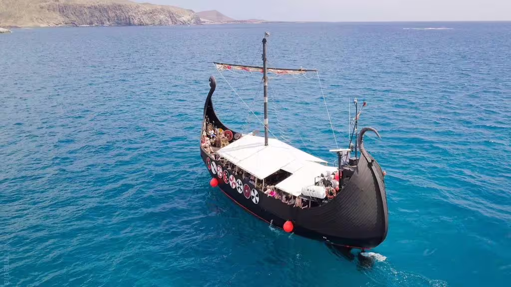Aerial view of a Viking ship cruising through clear blue waters, highlighting the scenic 3h Viking Cruise experience.