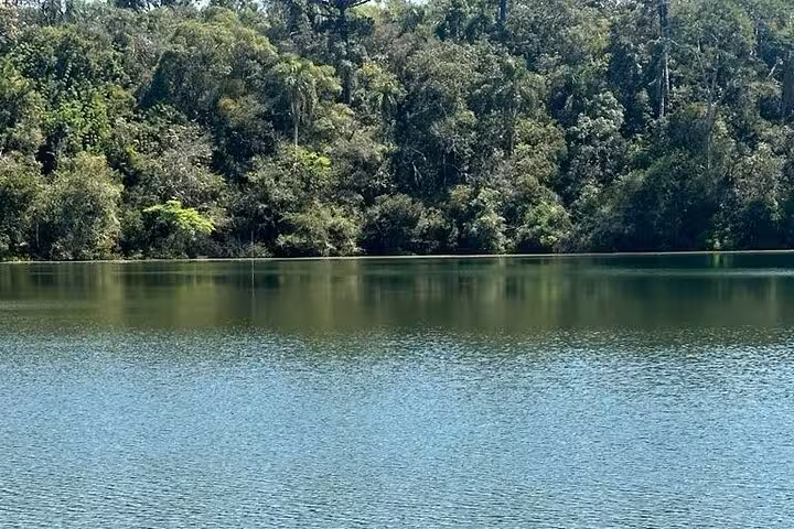 Serene lake reflecting lush forest at Vila Velha State Park, perfect for nature exploration and tranquility seekers.