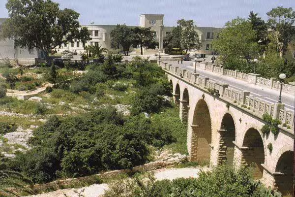 Historic arched stone bridge in Villa Castelli, Puglia, scenic stop on highlights walking tour and olive oil tasting