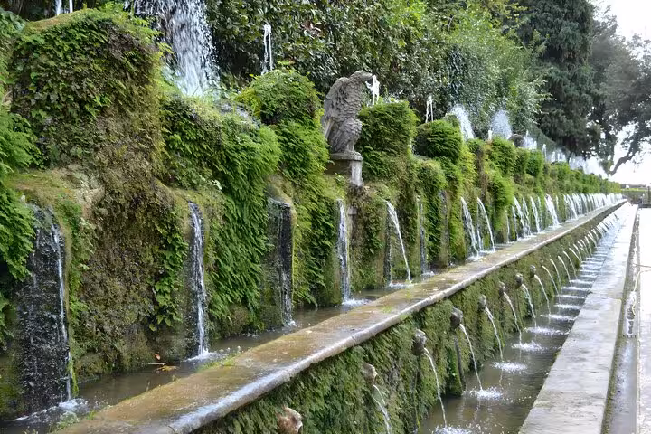 Lush green fountains at Villa d'Este, Tivoli, showcasing cascading water features in a serene garden setting.
