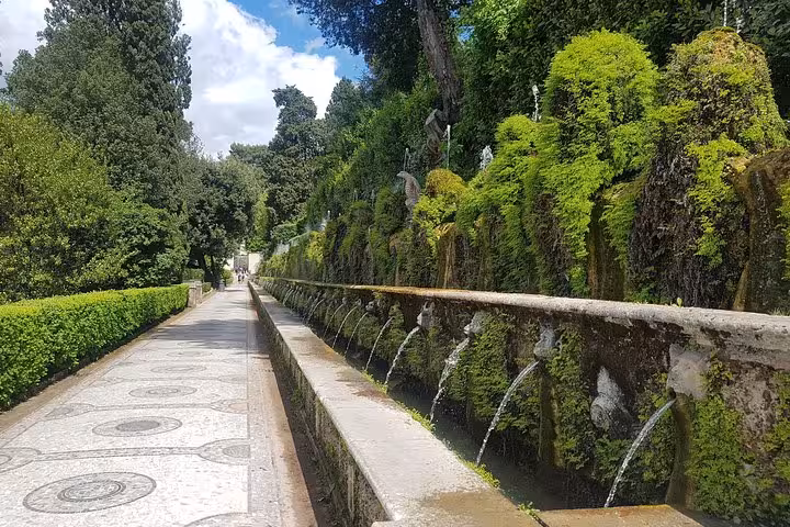 Villa d’Este Tivoli Hundred Fountains walkway on full-day Rome tour with mossy stone spouts and gardens