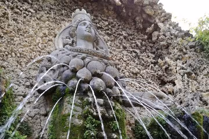 Villa d’Este Tivoli fountain statue with arcing water jets, highlight of full-day tour from Rome