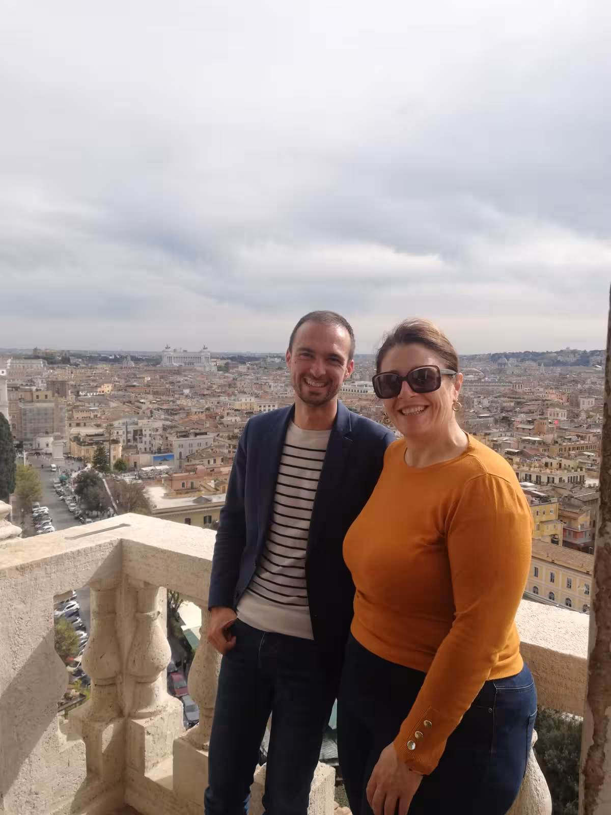 Visitors posing on Villa Medici balcony with panoramic Rome cityscape view, part of Combo Tour.