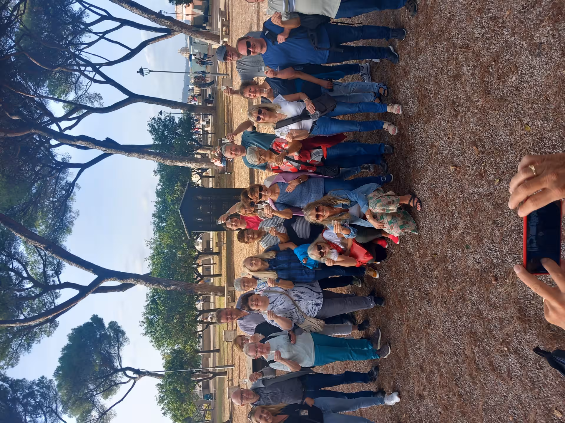 Group of tourists enjoying a sunny day at the scenic Villa Medici gardens during a combo tour in Rome.