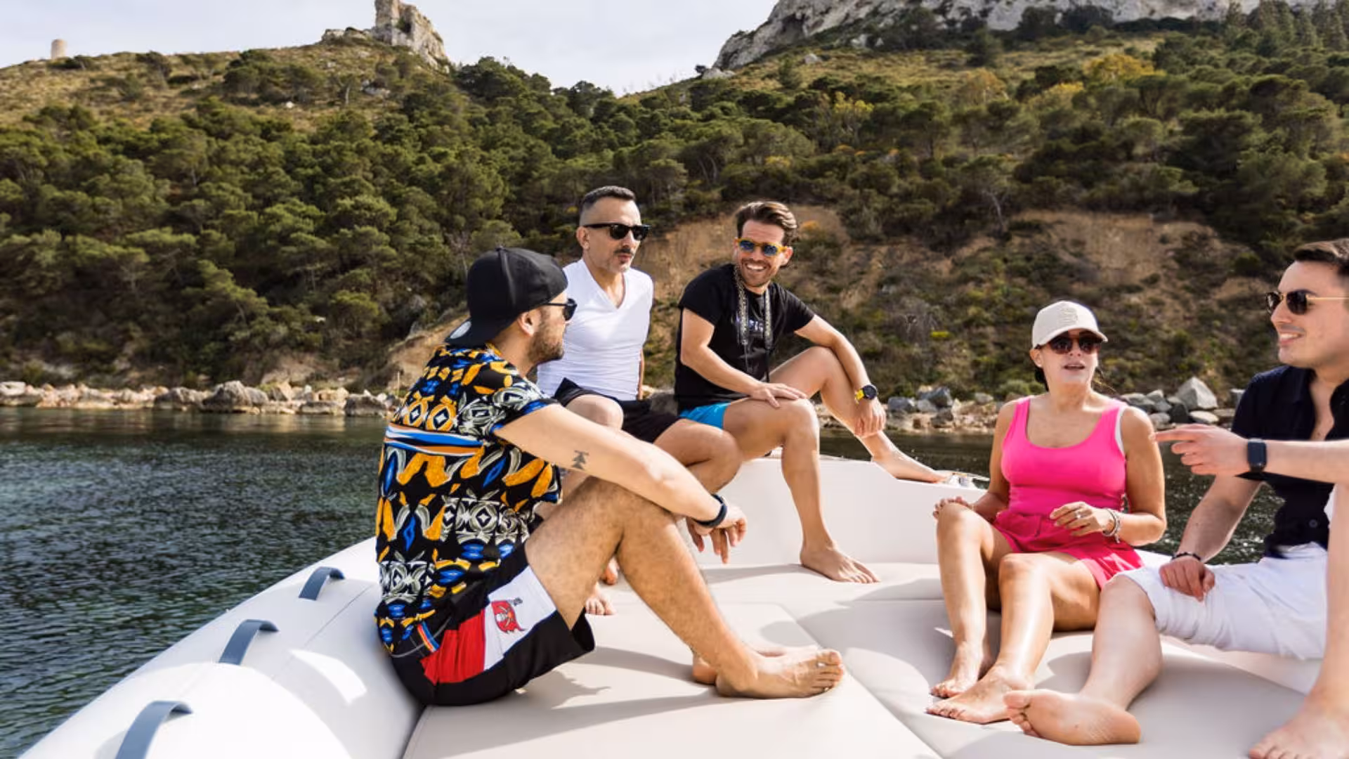 Group enjoying a dinghy ride along Villasimius coast, exploring stunning landscapes and serene waters.