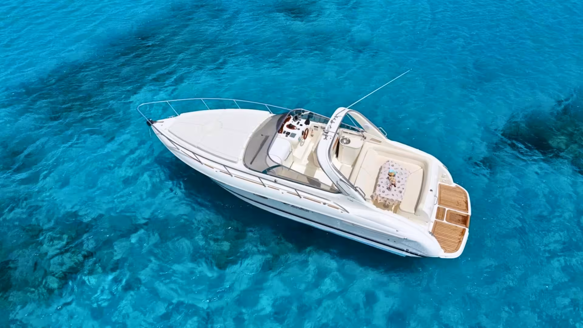 Aerial view of a private speedboat cruising over crystal-clear waters in Villasimius, perfect for exclusive tours.