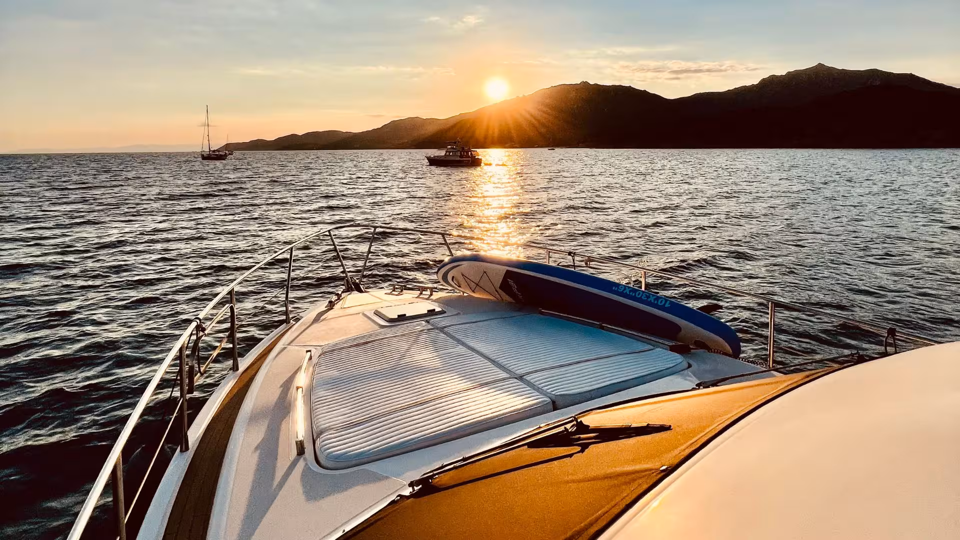 Witness a breathtaking sunset over the sea from the deck of a private yacht during a Villasimius tour.