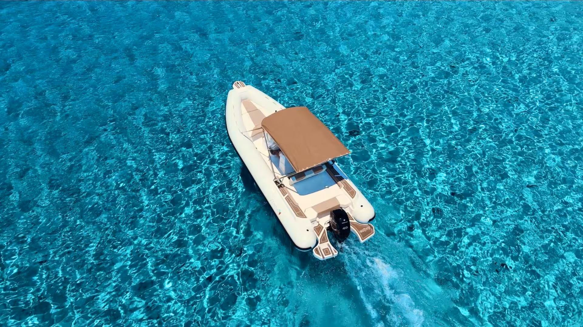 RIB cruising through crystal-clear waters in Villasimius, offering an exhilarating rental experience for groups of eight.