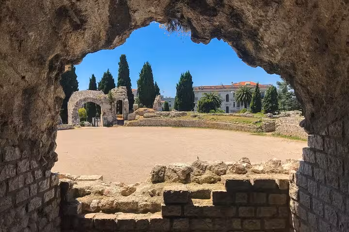 Ancient stone ruins in Villefranche sur Mer, France, viewed through an archway, emphasizing historical exploration.