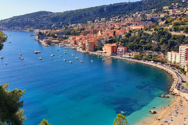 Villefranche-sur-Mer's stunning coastline with vibrant buildings and clear waters, a highlight of the private tour experience.