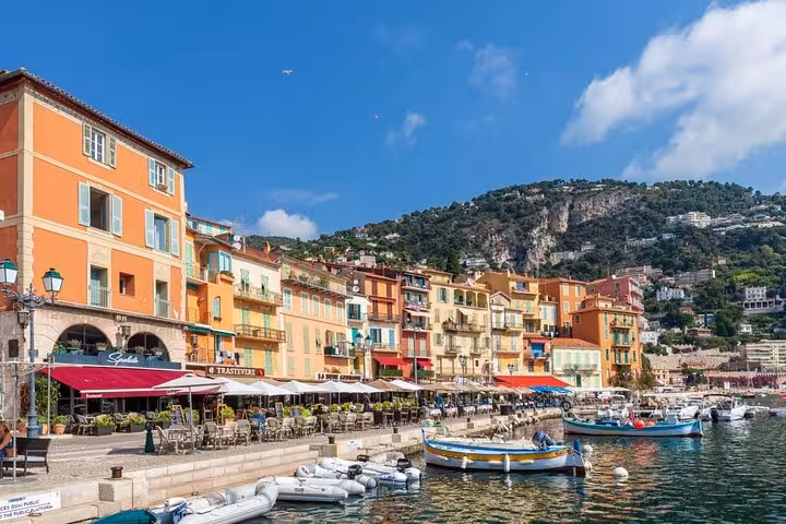 Scenic view of colorful waterfront buildings and boats in Villefranche-sur-Mer, a highlight of the Nice, Monaco, Eze tour.