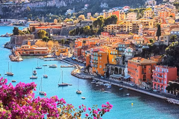 Colorful hillside town of Villefranche-sur-Mer with yachts in bay, a highlight of the French Riviera tour.