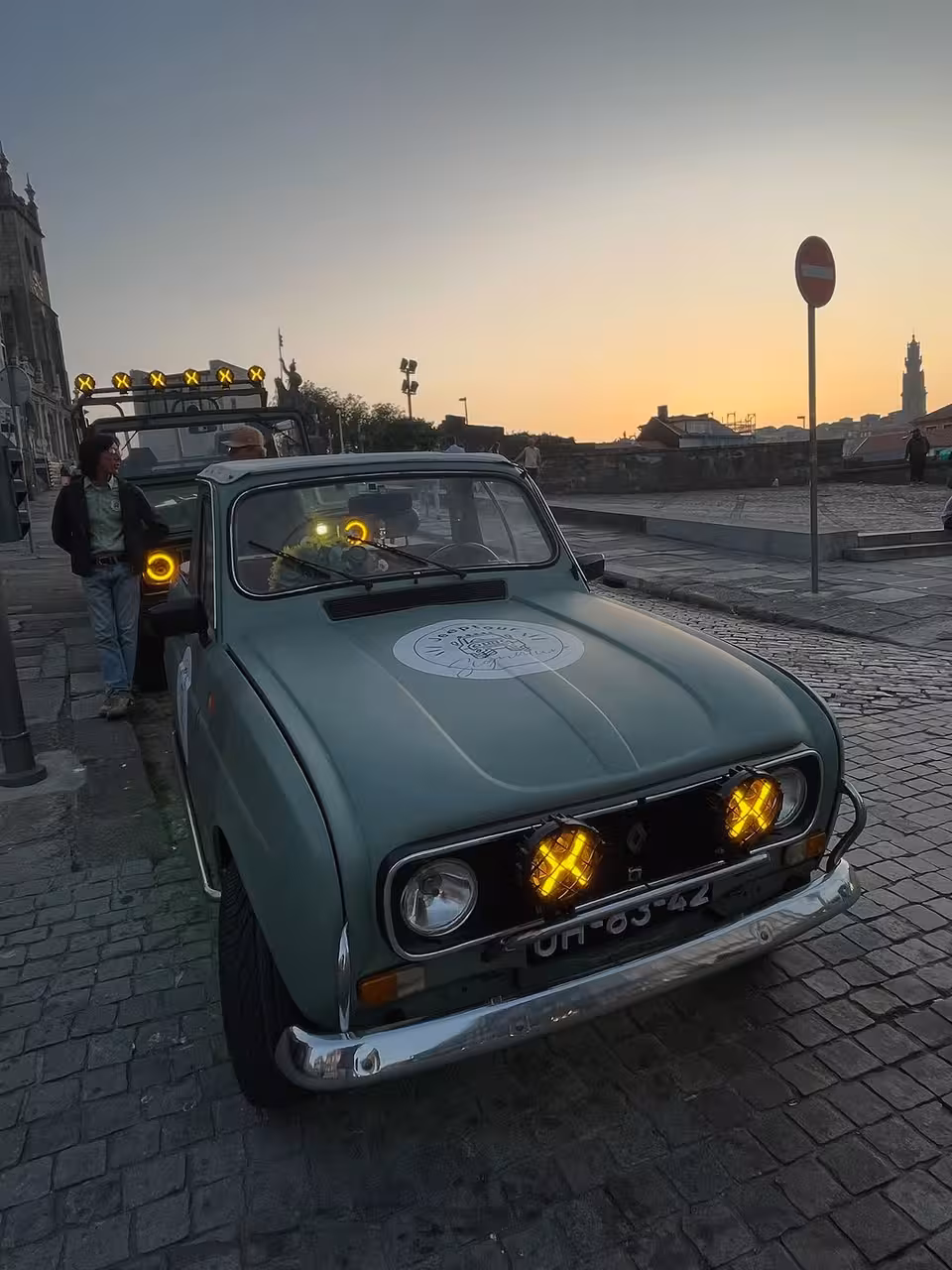 Vintage car at sunset on Porto riverside, ideal for Porto by Night Douro River romance and city lights tour
