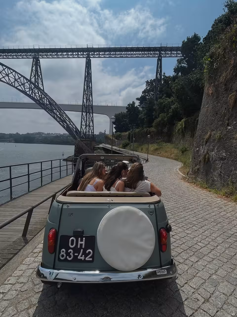 Vintage convertible drive by the Douro River under Dom Luís I Bridge, Porto Gaia sightseeing tour experience