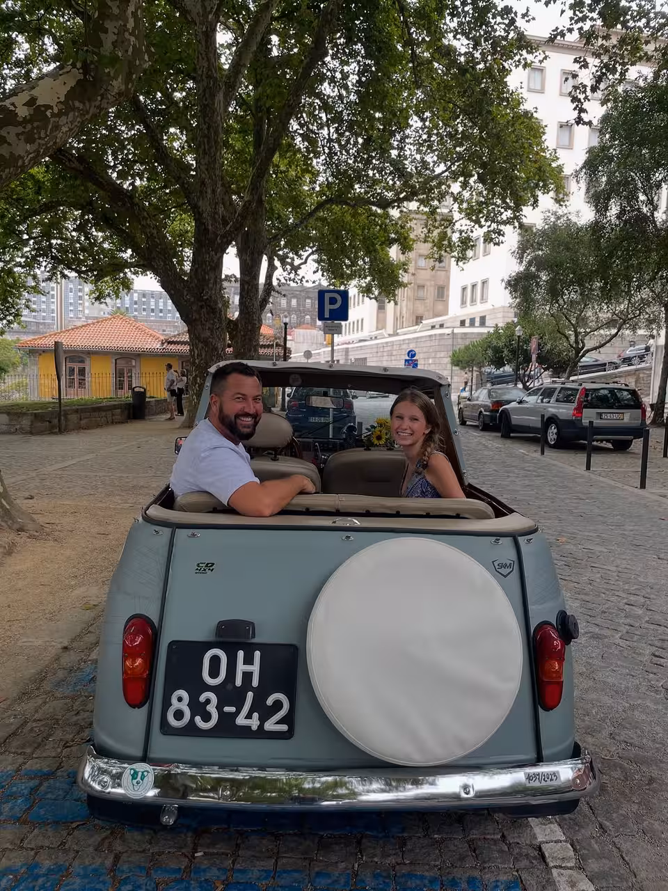 Couple in vintage convertible on Porto street, North Coast Adventure tour blending culture, history and city views
